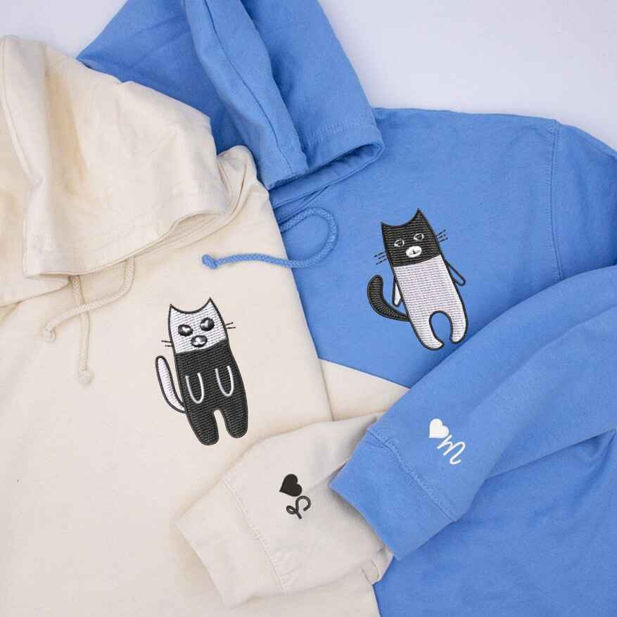 Minimalist embroidered cat design on cozy matching sweatshirts
