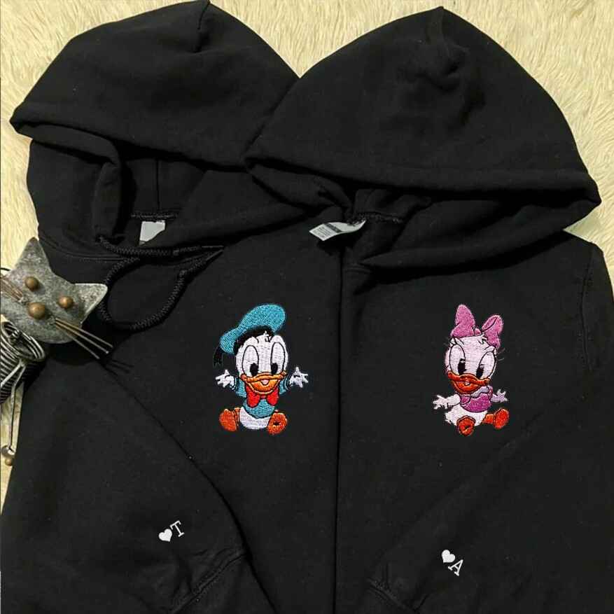 Cozy couple hoodies with embroidered Donald and Daisy Duck designs
