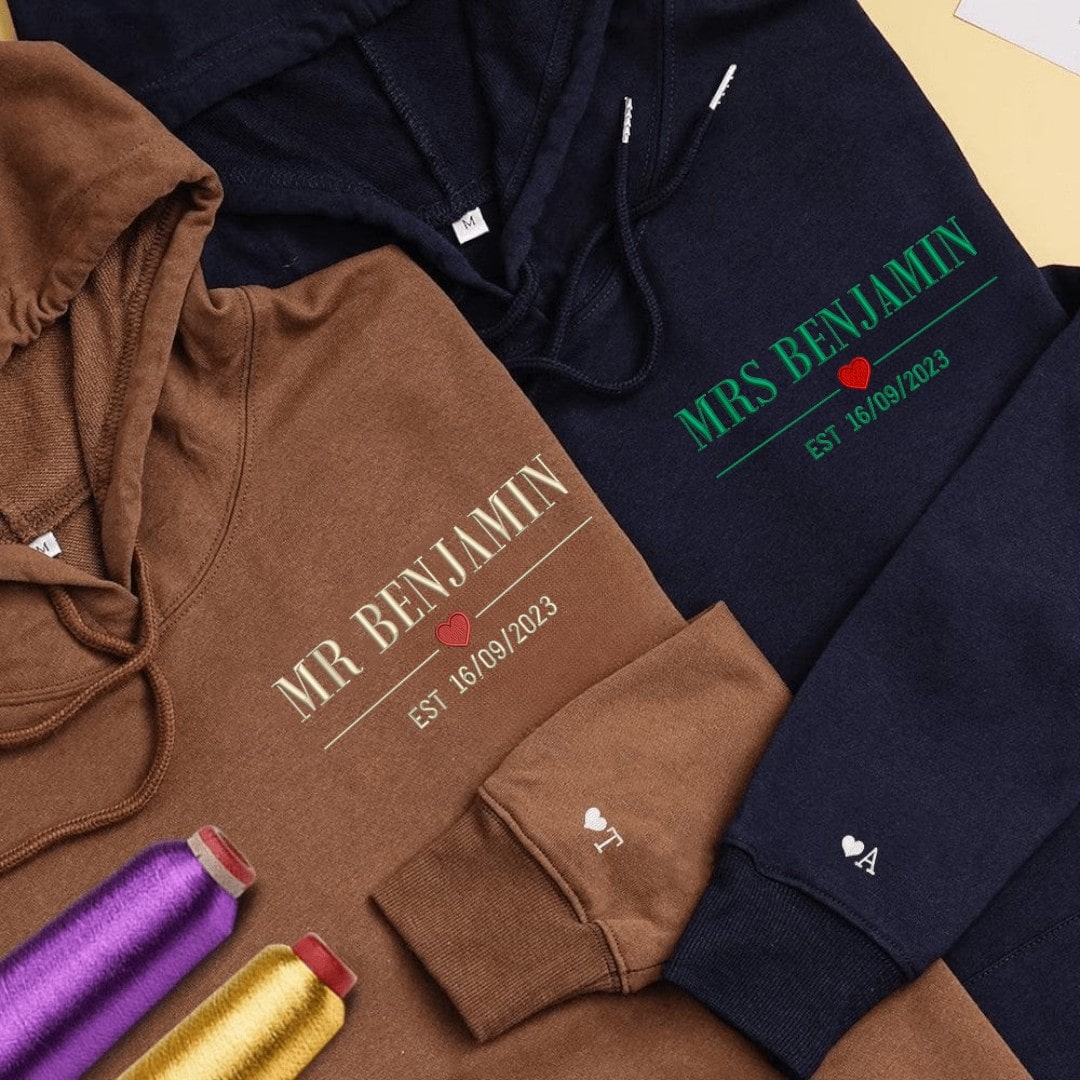 Custom brown and navy couple hoodies with personalized embroidery details