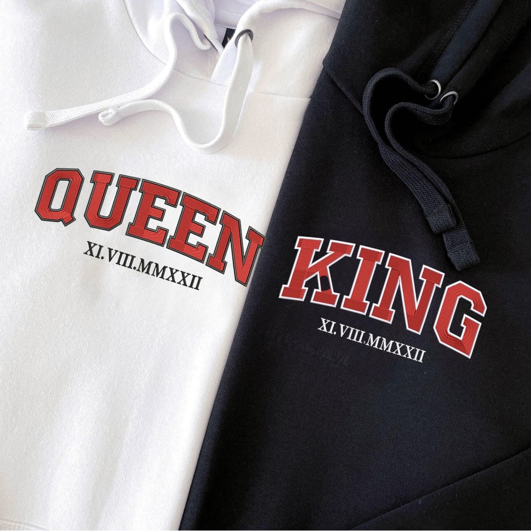 Close-up of personalized couple hoodies featuring Roman date embroidery