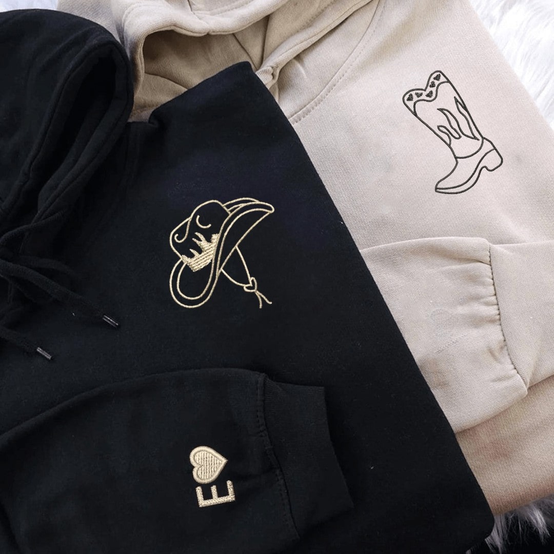 Close-up of cowboy boot and hat embroidery on couple sweatshirts