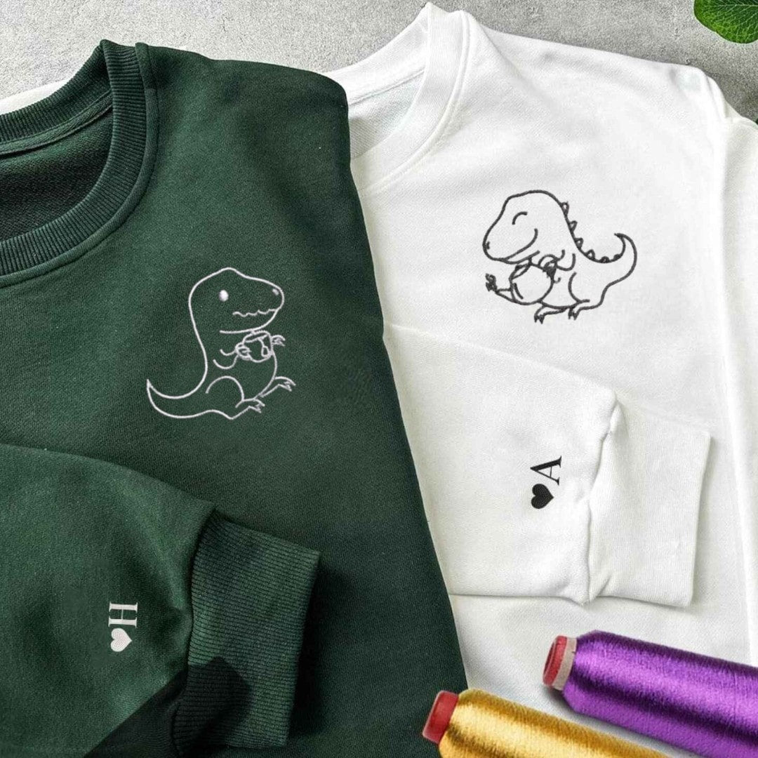 Cute dinosaur sipping tea illustration on couple hoodies