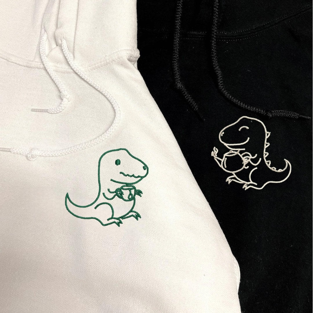 Matching hoodies for tea-loving couples featuring playful dinosaurs