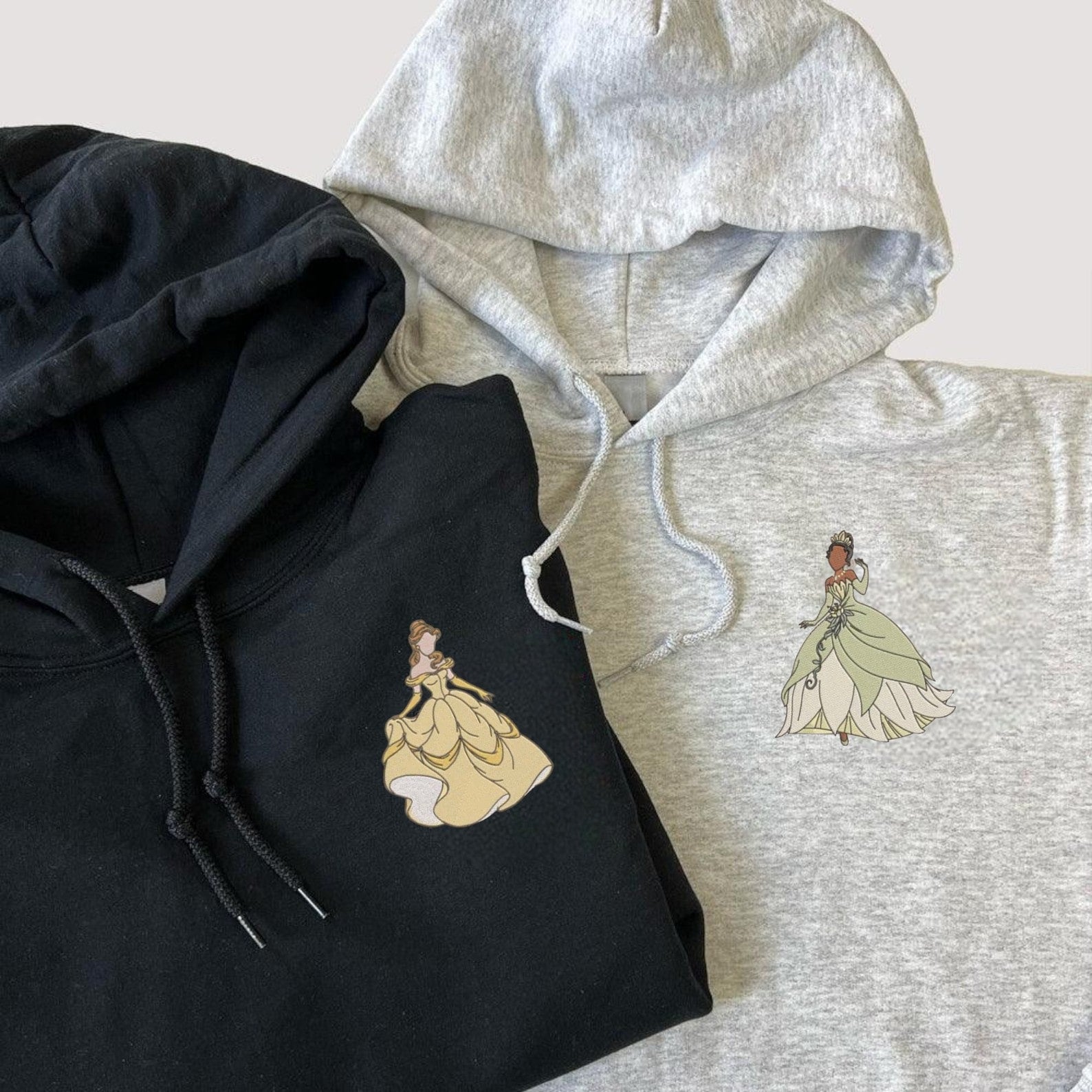 Cartoon Princess Couple hoodies in black and gray with elegant designs.