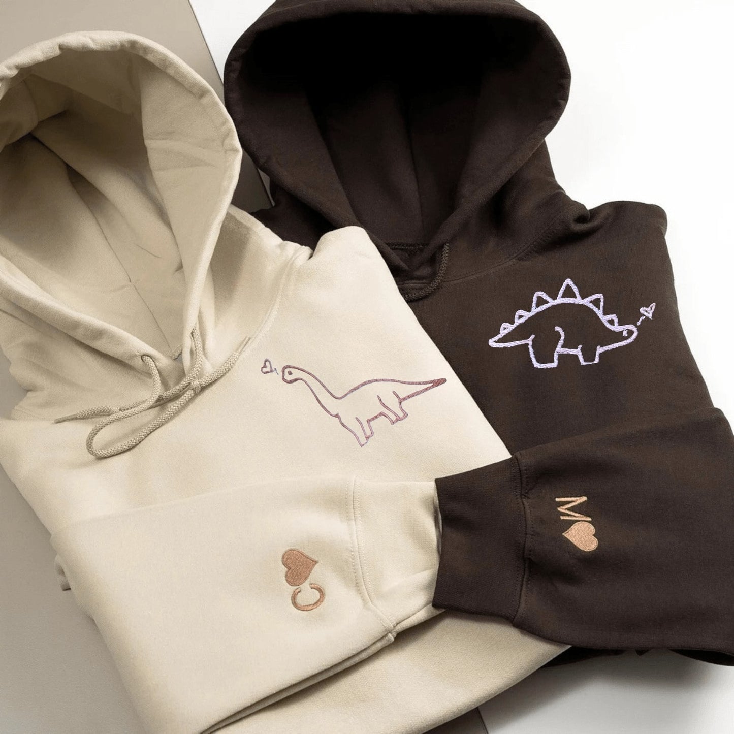 Matching Couple Hoodies featuring playful dinosaur graphics, ideal matching couple sweatshirts.
