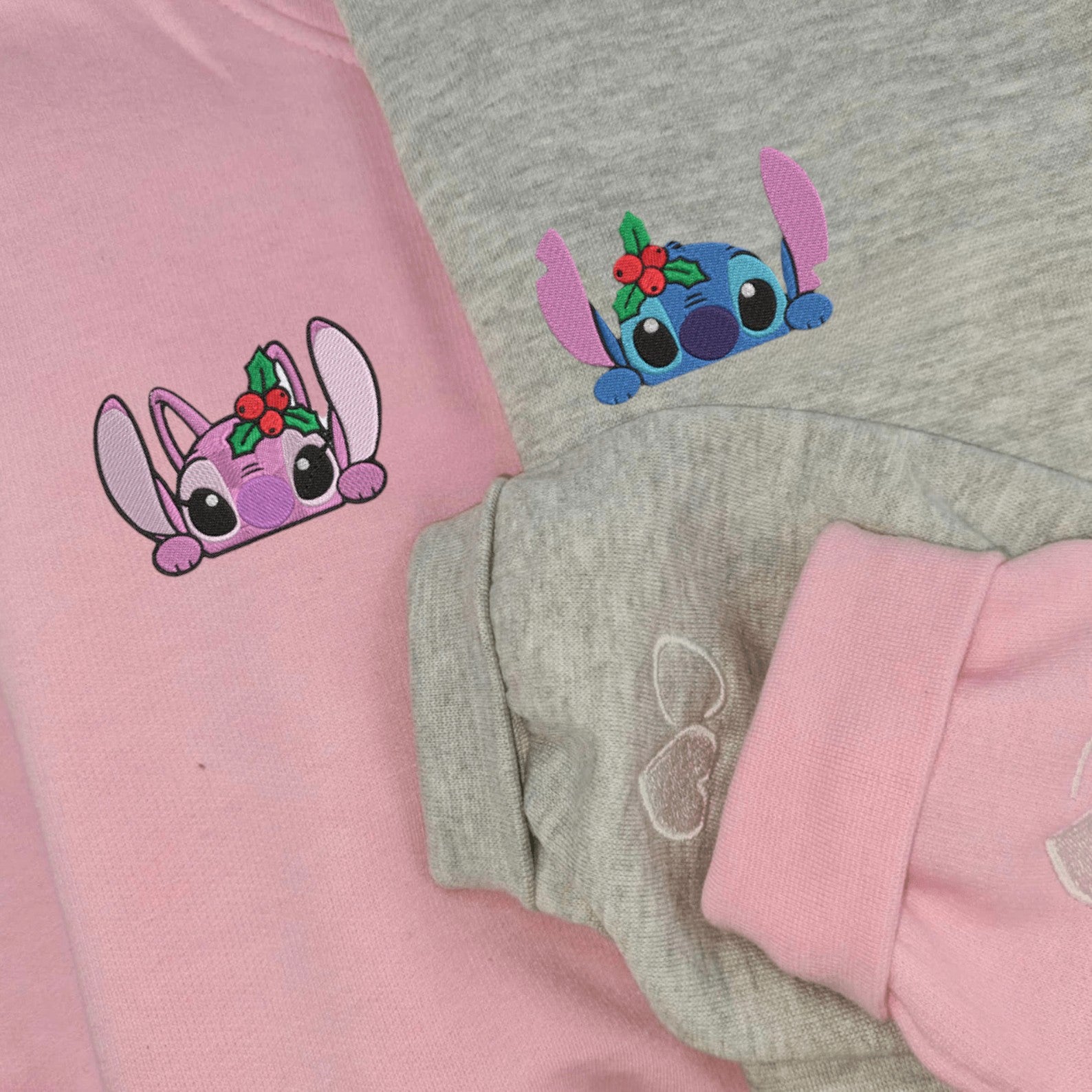 Matching Couple Hoodies with holiday-themed Stitch and Angel graphics, ideal matching couple sweatshirts.
