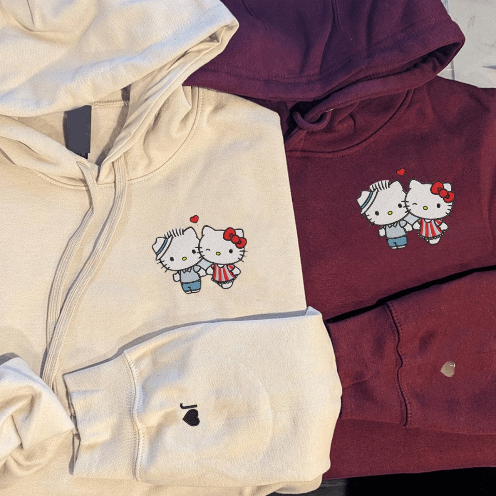 Custom embroidered graphic meme shirts showcasing kittens holding hands on customizable hoodies, perfect for fans of funny meme t-shirts.
