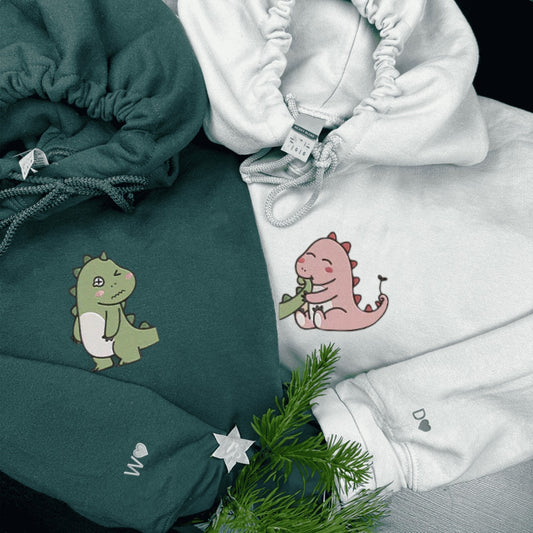 Matching Couple Hoodies with adorable dinosaur designs, ideal for matching couple sweatshirts.
