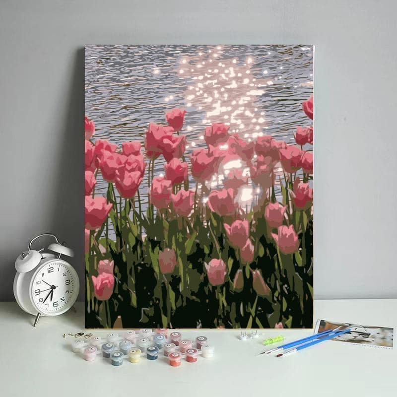 DIY painting kit featuring pink tulips by a calm lakeside.