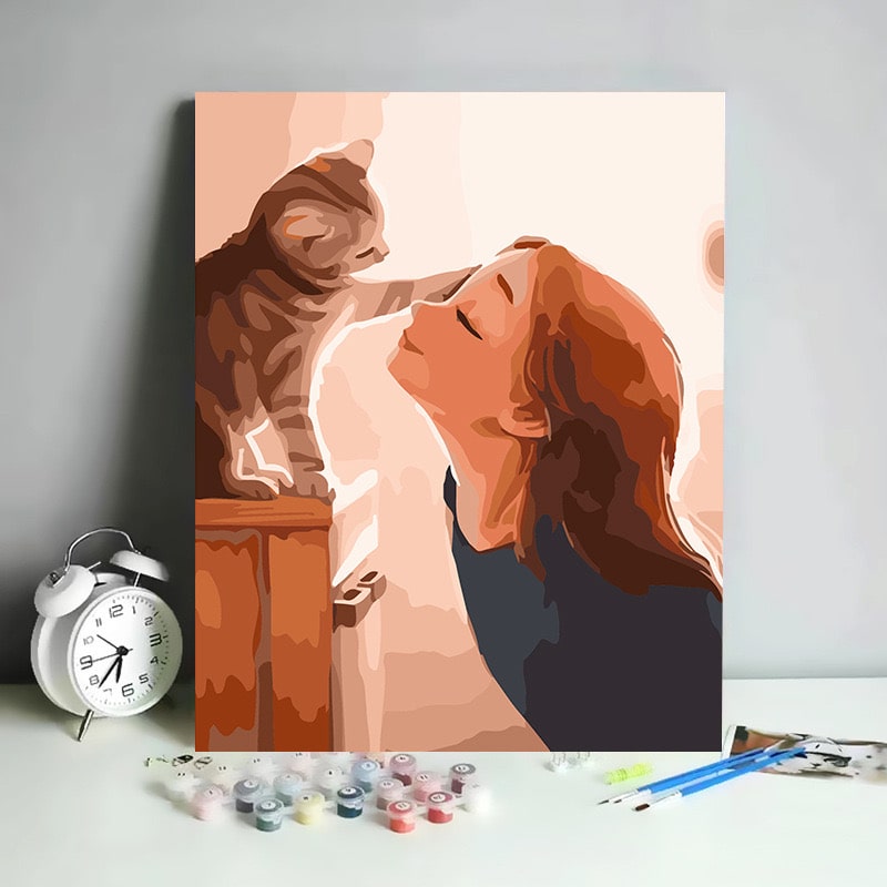 Paint by numbers kit featuring a girl sharing a moment with a cat.