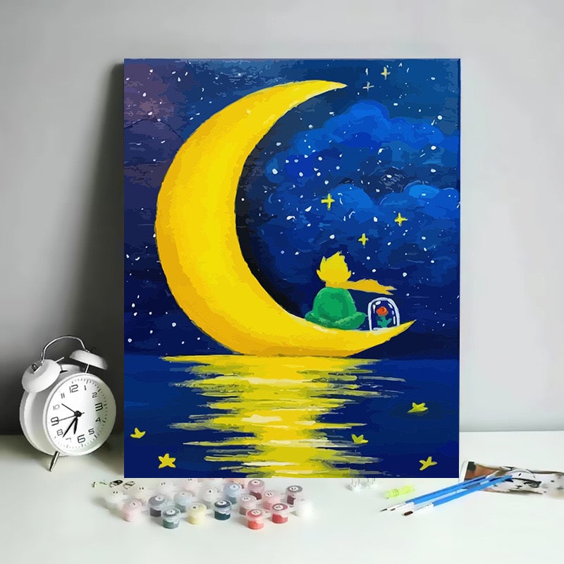 Paint by numbers kit featuring a child on a crescent moon under a starry sky.