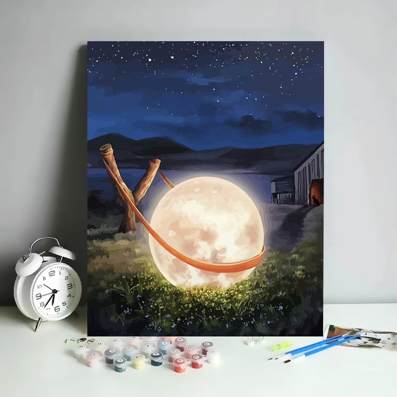 Paint by numbers canvas featuring a moon in a slingshot under a starry night.