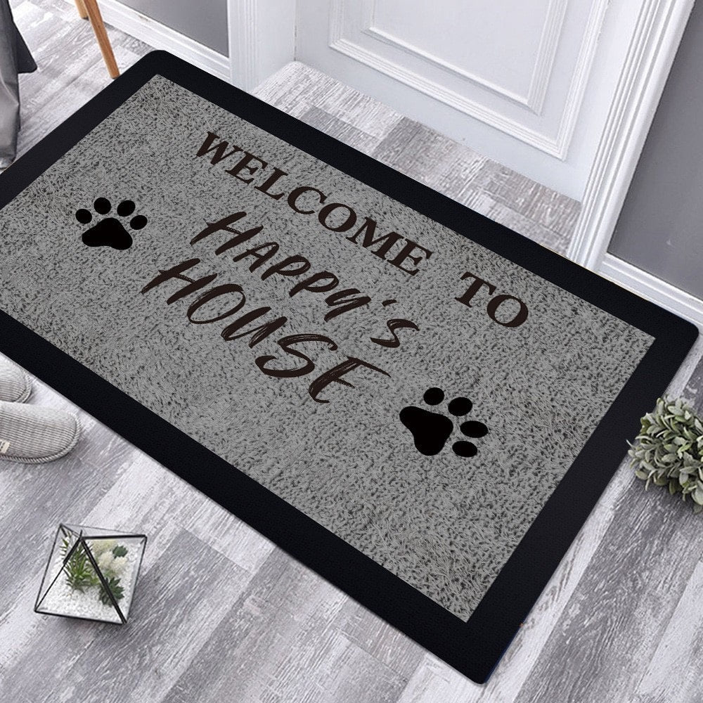 Personalized pet welcome mat with paw prints and custom message