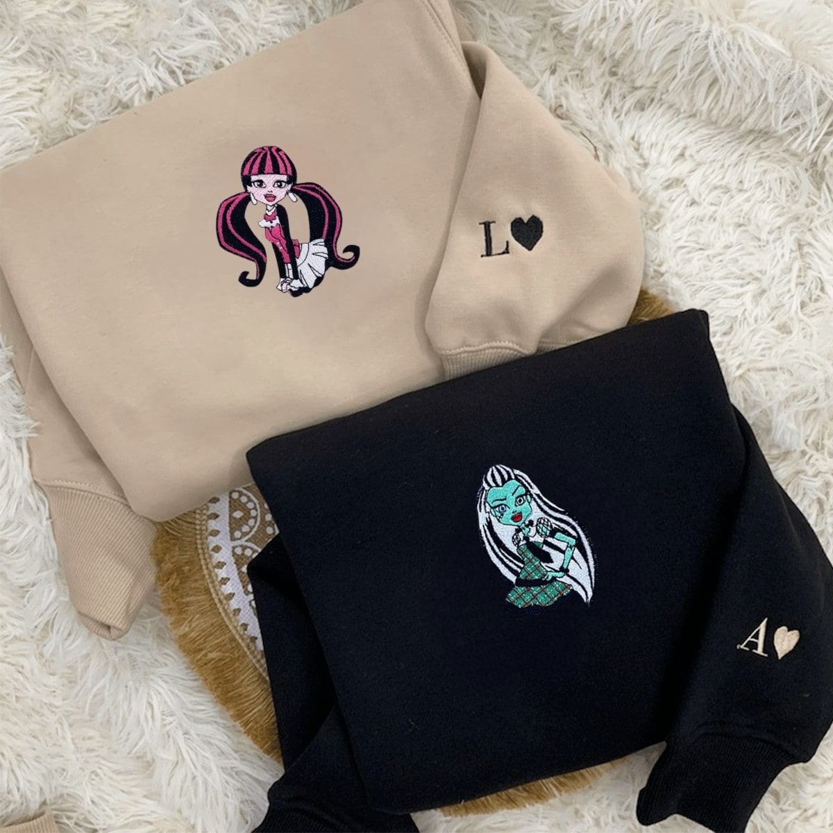 Matching couple hoodies with monster-inspired designs and quirky details.