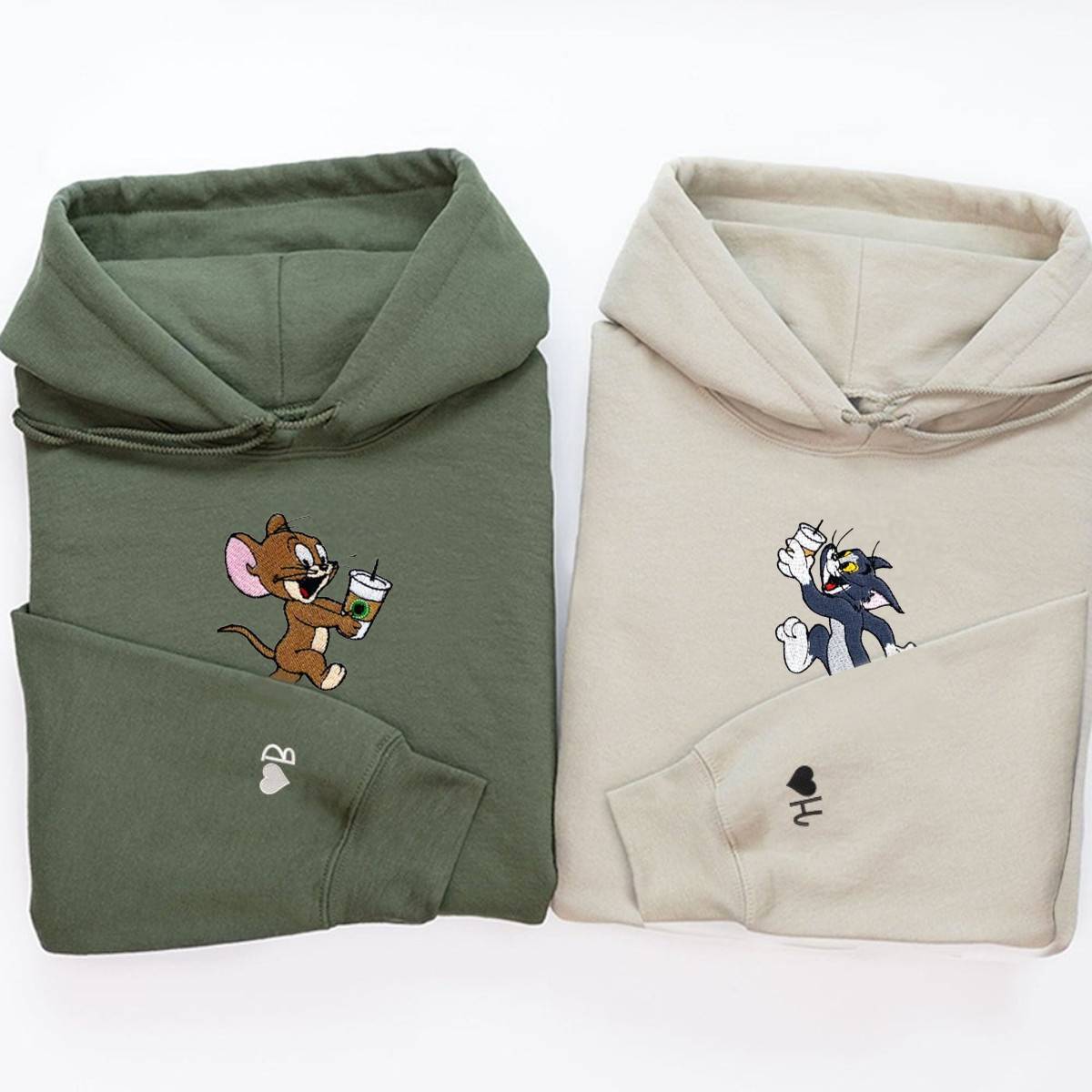 Matching couple hoodies with embroidered playful cat and mouse designs.