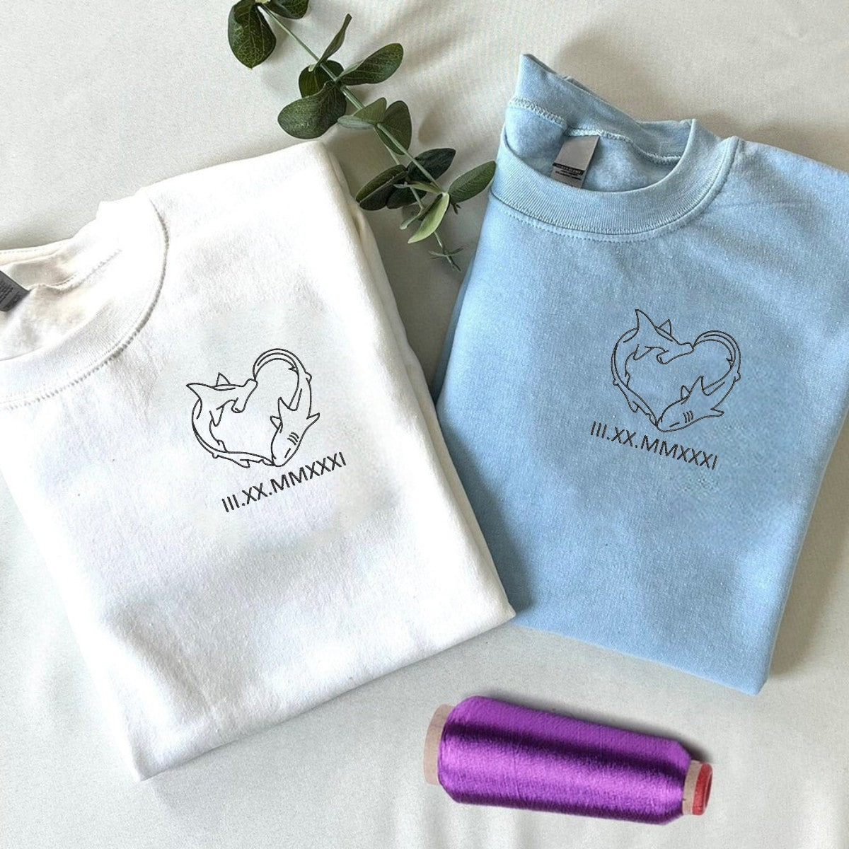 Matching couple sweatshirts featuring personalized initials and love-themed embroidery.