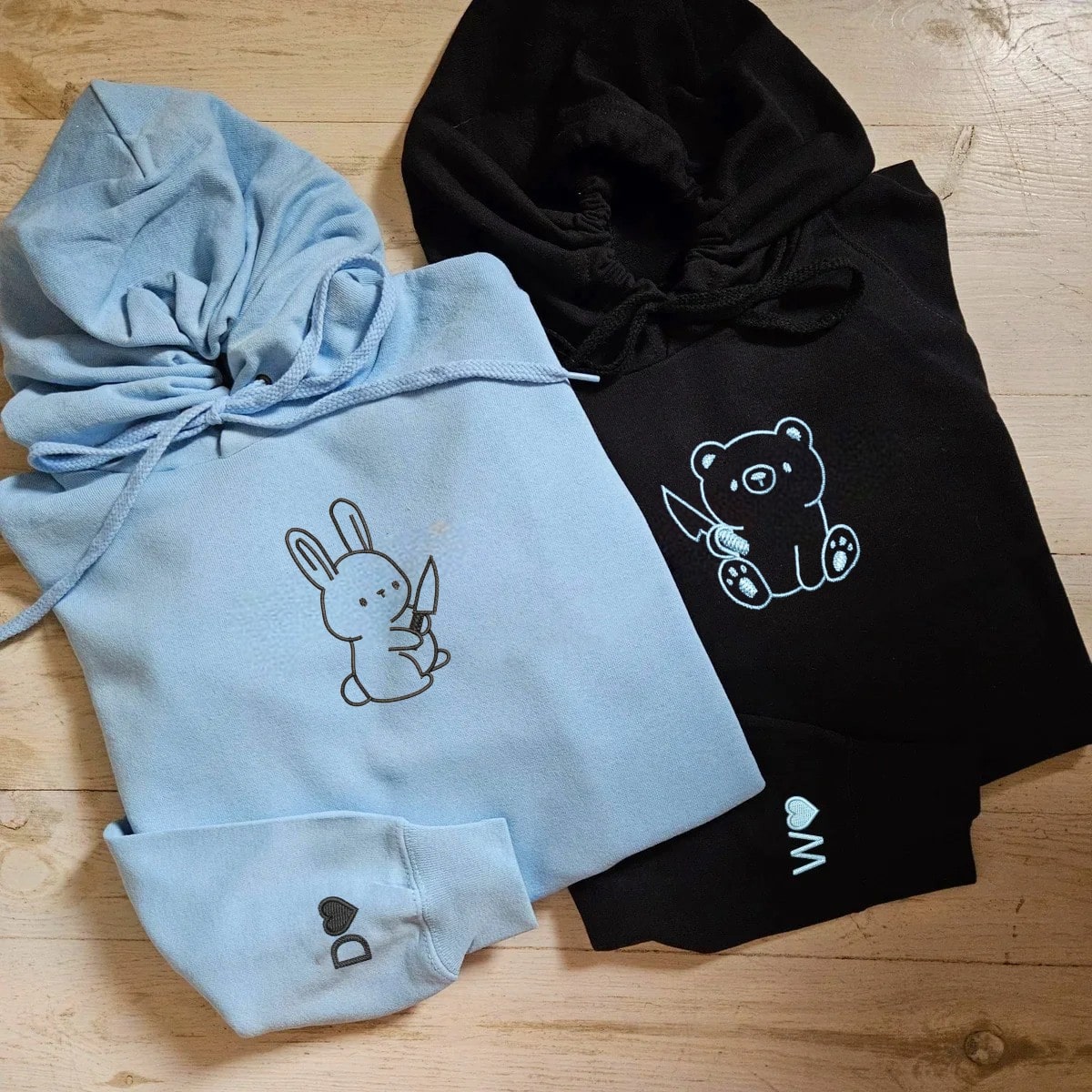 Matching couple hoodies with playful bear and rabbit designs and personalized heart details.