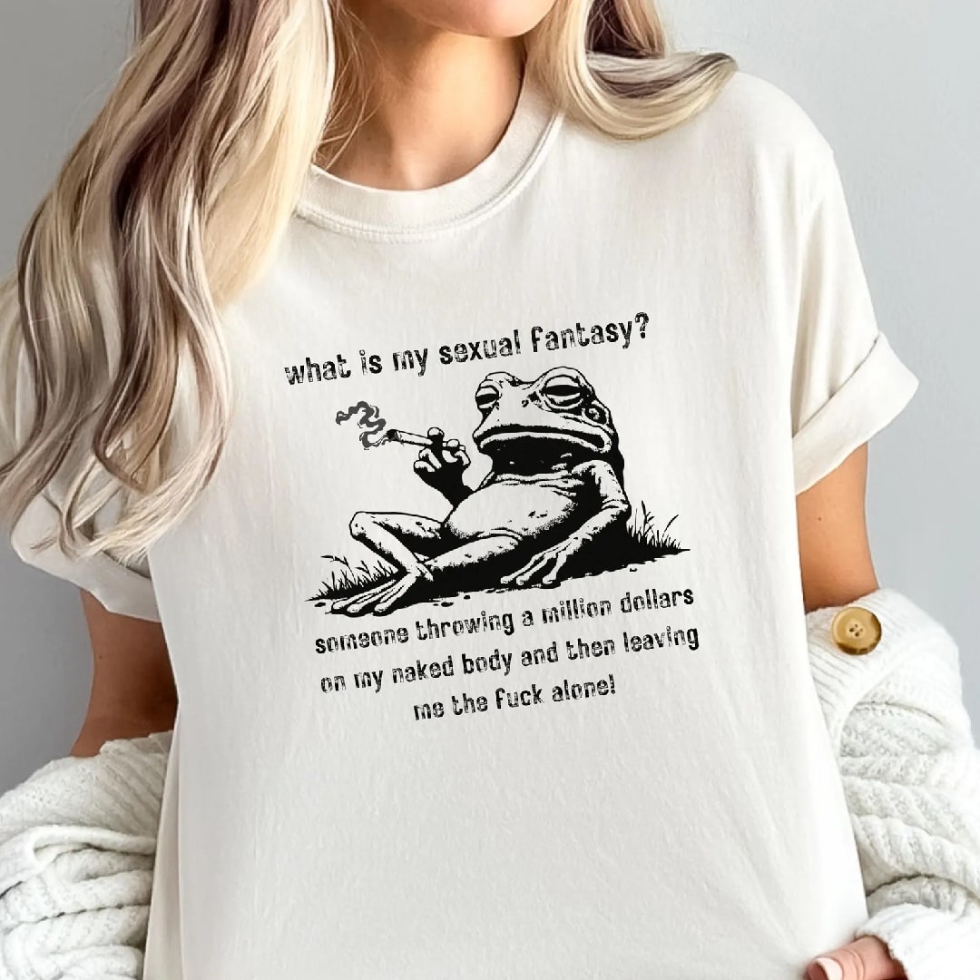 White t-shirt with a frog design smoking a cigarette and the playful slogan 'What is my sexual fantasy?