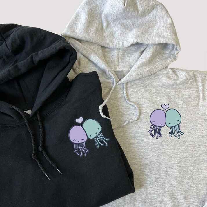 Light blue and navy couple hoodies with embroidered pastel jellyfish, perfect for a matching outfit.
