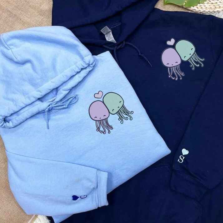 Cute jellyfish embroidered matching hoodies for couples in blue and navy, adorable pastel jellyfish design.
