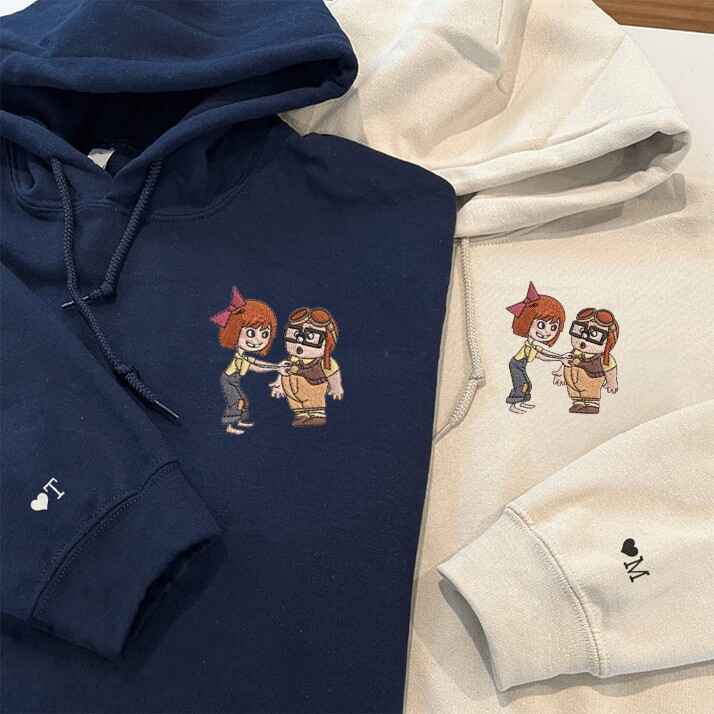 Embroidered adventurous couple hoodies in light blue and navy, matching outfits for couples.
