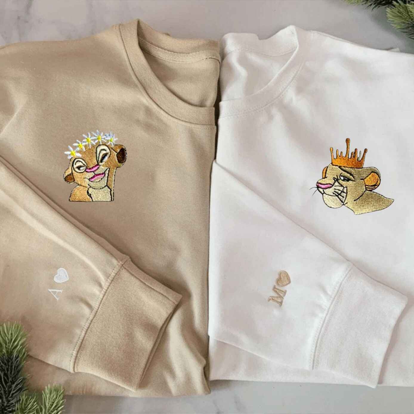 Matching lion couple sweatshirts with floral and royal crowns
