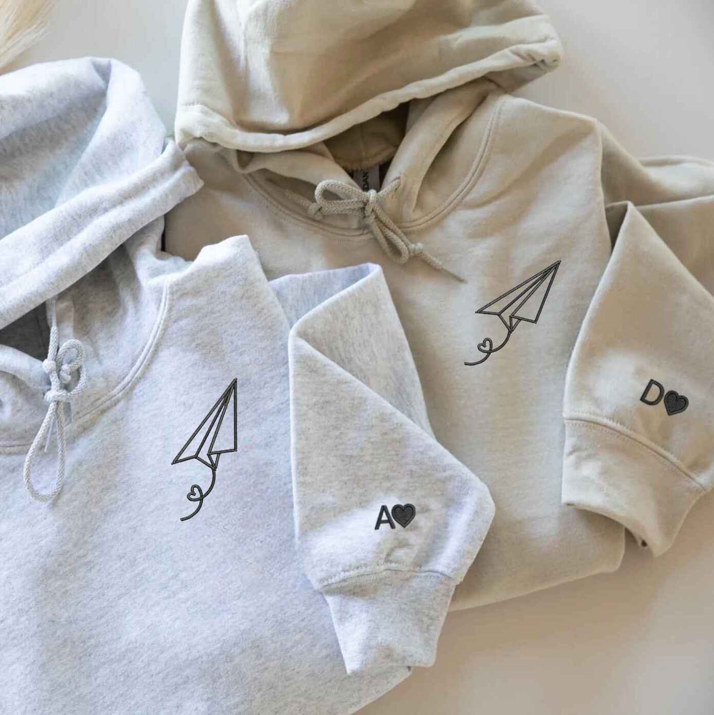 Matching Couple Hoodies with couples matching hoodies design featuring paper plane and heart trail
