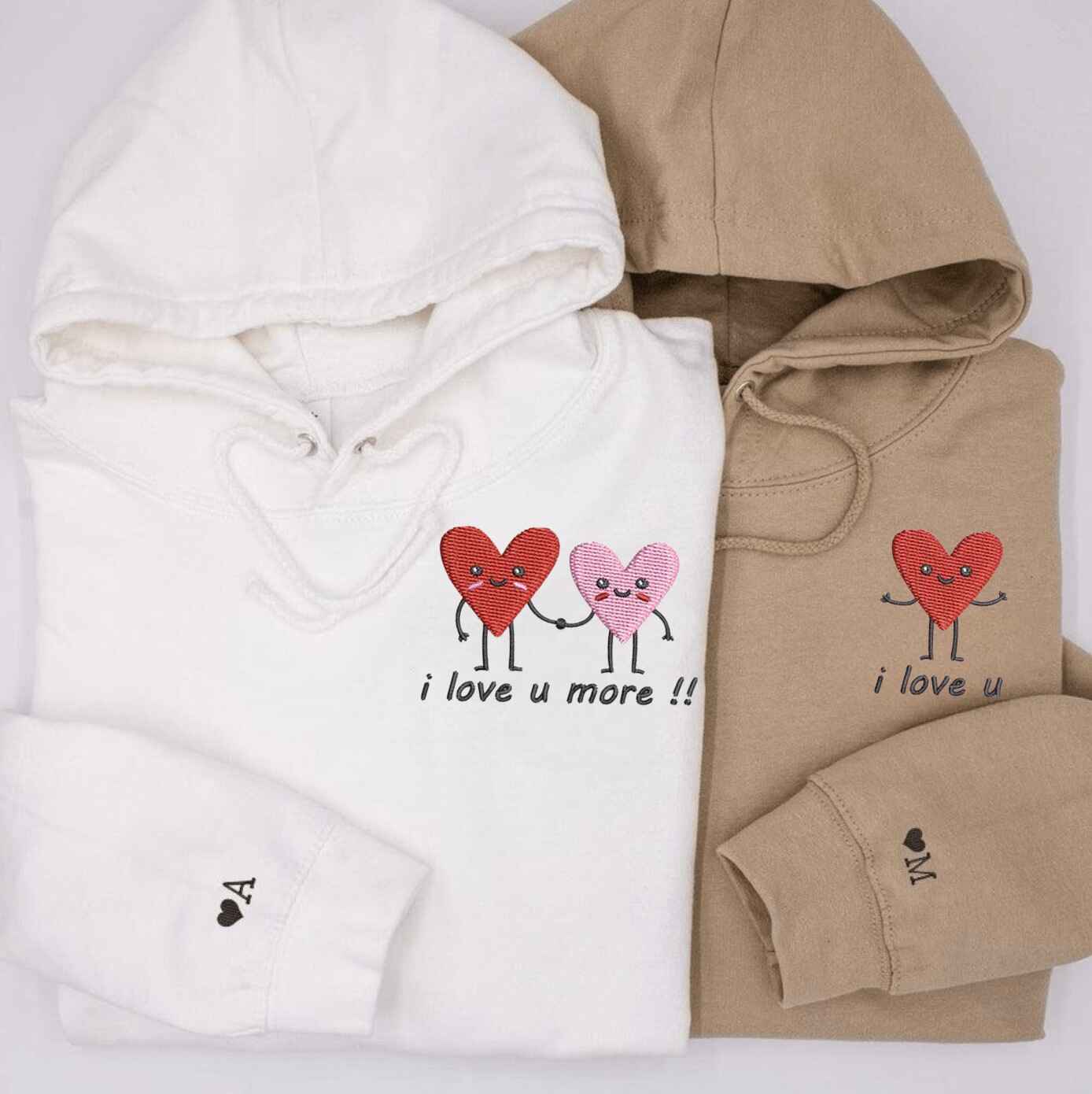 Matching couple hoodies with "I Love You, I Love You More" heart designs
