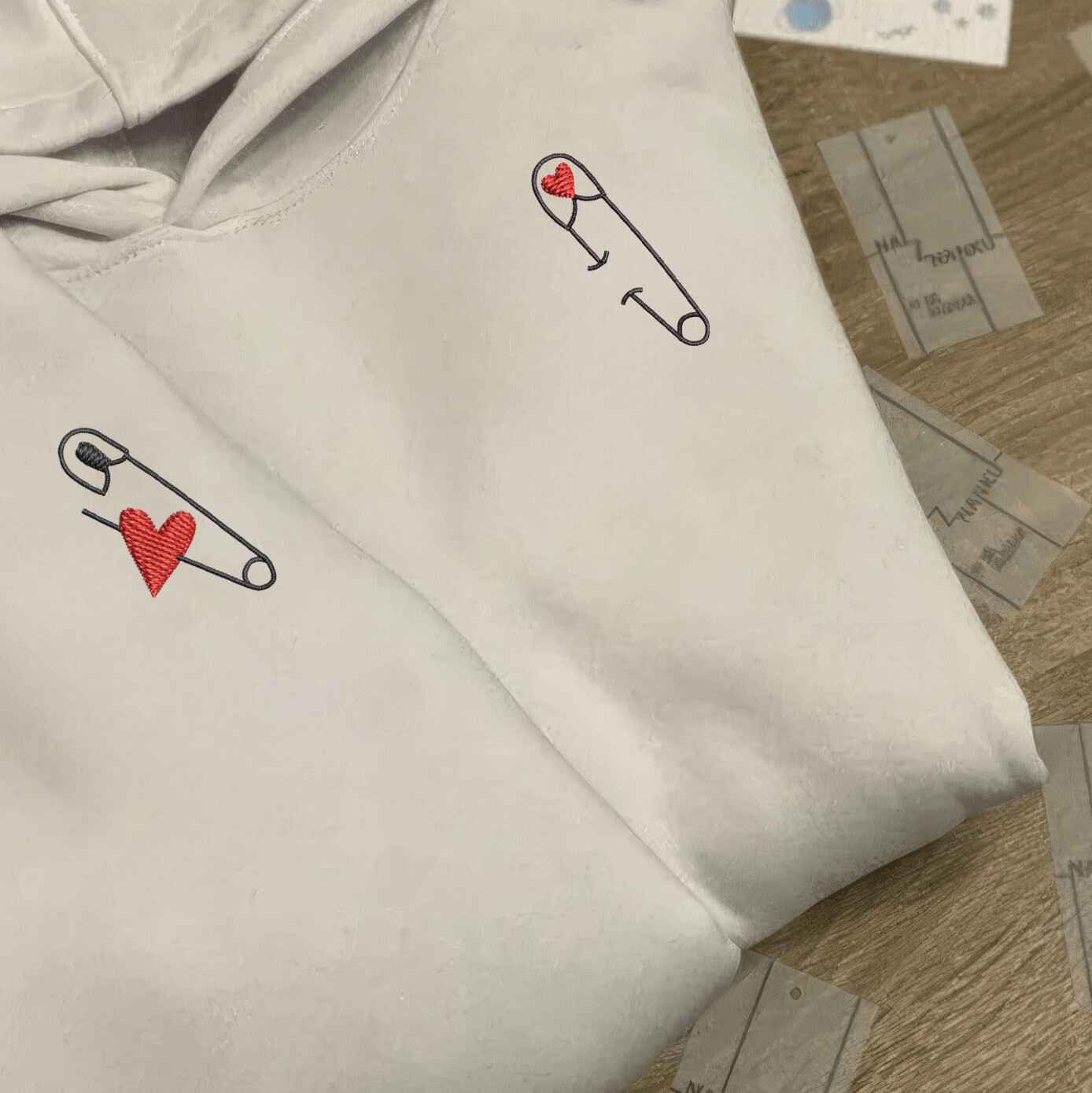 Matching Couple Hoodies with love-inspired matching couple sweatshirts showcasing heart safety pin design
