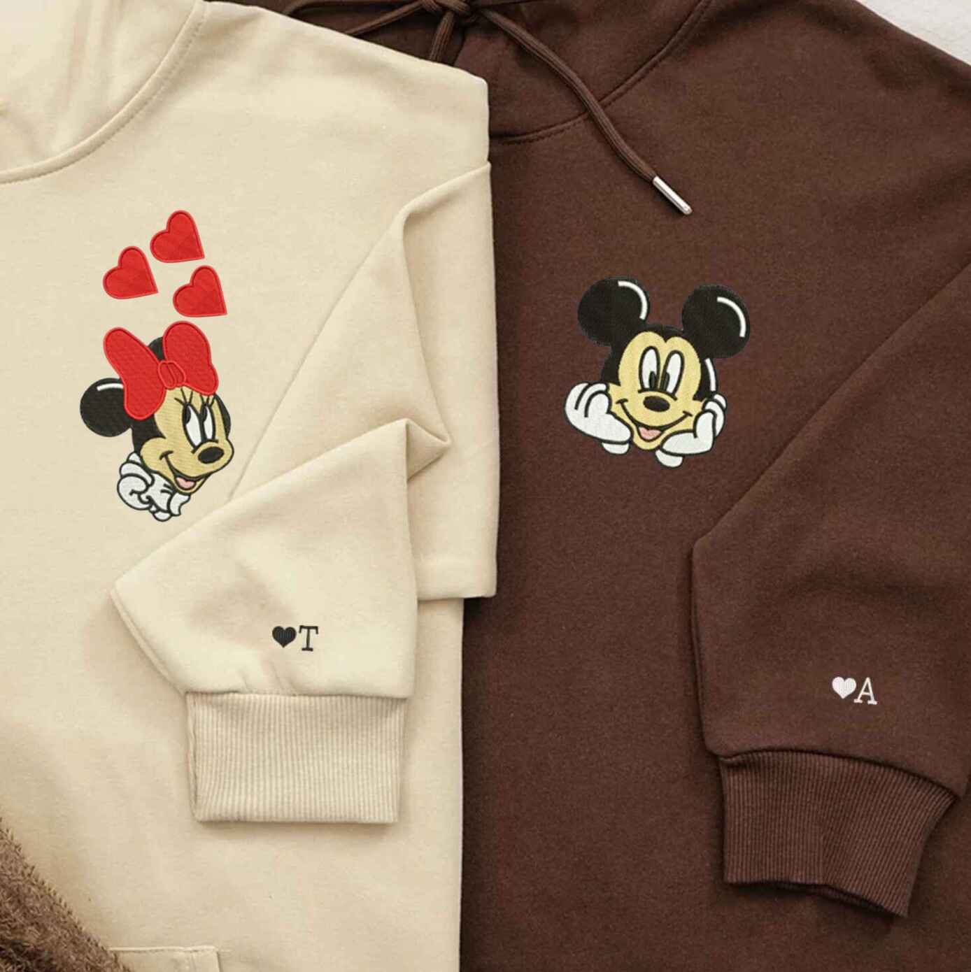 Matching Mickey and Minnie couple hoodies with embroidered designs
