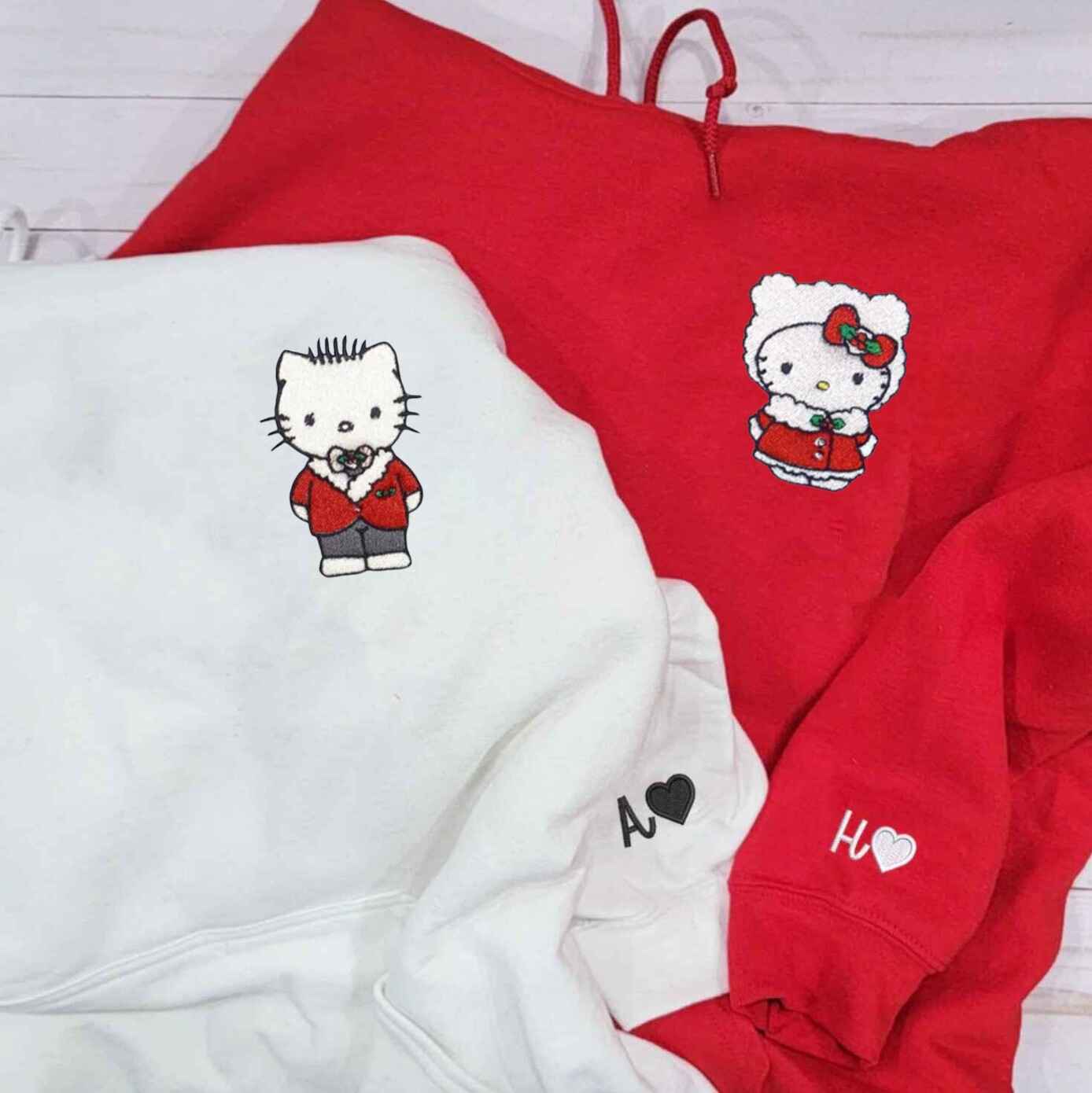 Christmas couple hoodies with festive kitten design
