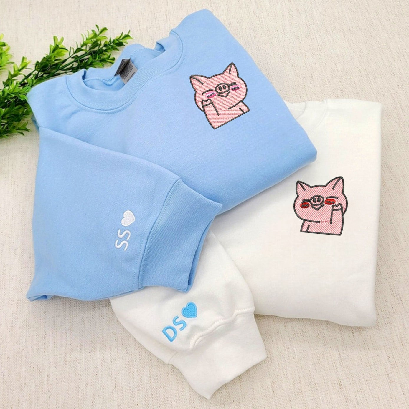 Couple hoodies with fun embroidered pig design
