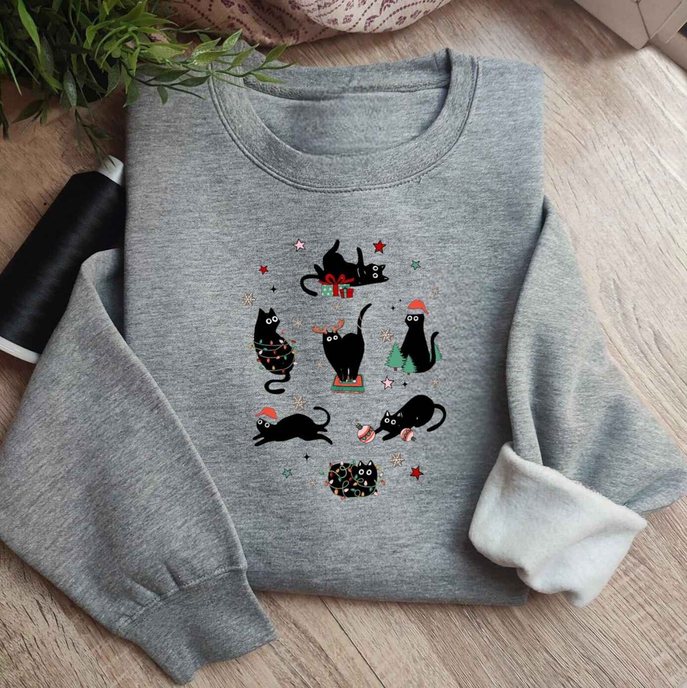 Red Christmas sweatshirt with festive black cats
