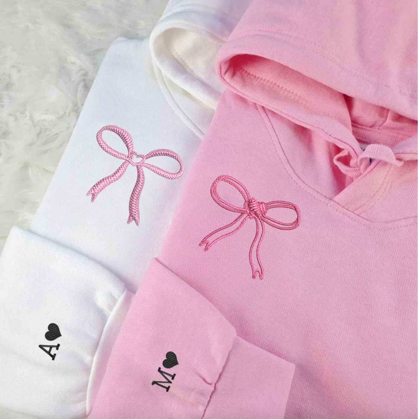 Matching hoodies featuring an embroidered ribbon motif
