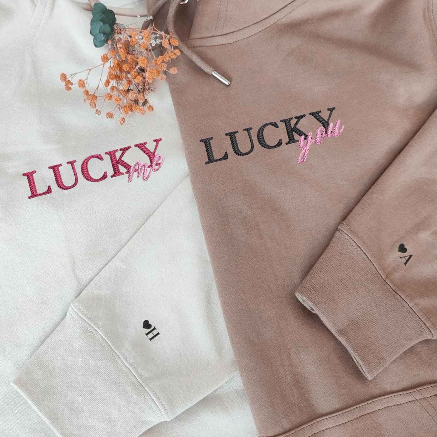 Matching couple hoodies with "Lucky Me, Lucky You" embroidered text
