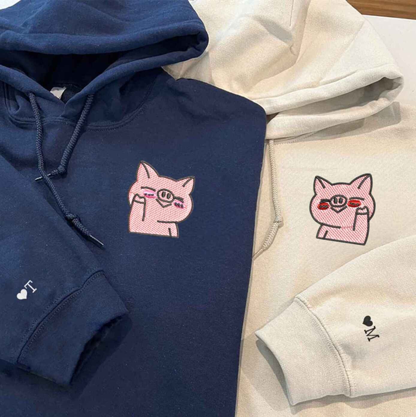 Couple hoodies with fun embroidered pig design
