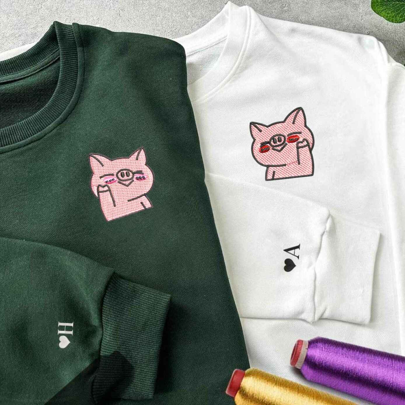 Couple hoodies with fun embroidered pig design
