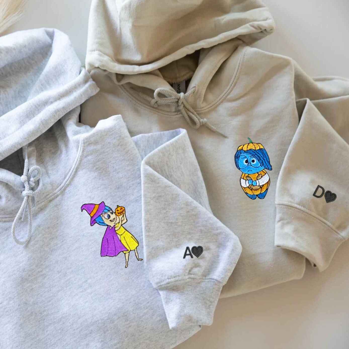 Matching Halloween-themed hoodies for couples with embroidered characters
