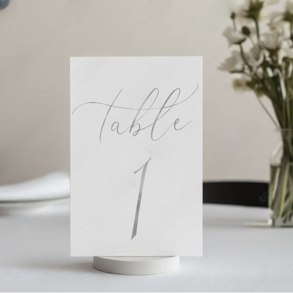 Elegant gold foil table number 1 displayed at a wedding