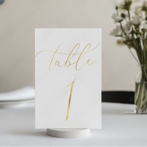 Premium gold foil wedding table number with elegant cursive font
