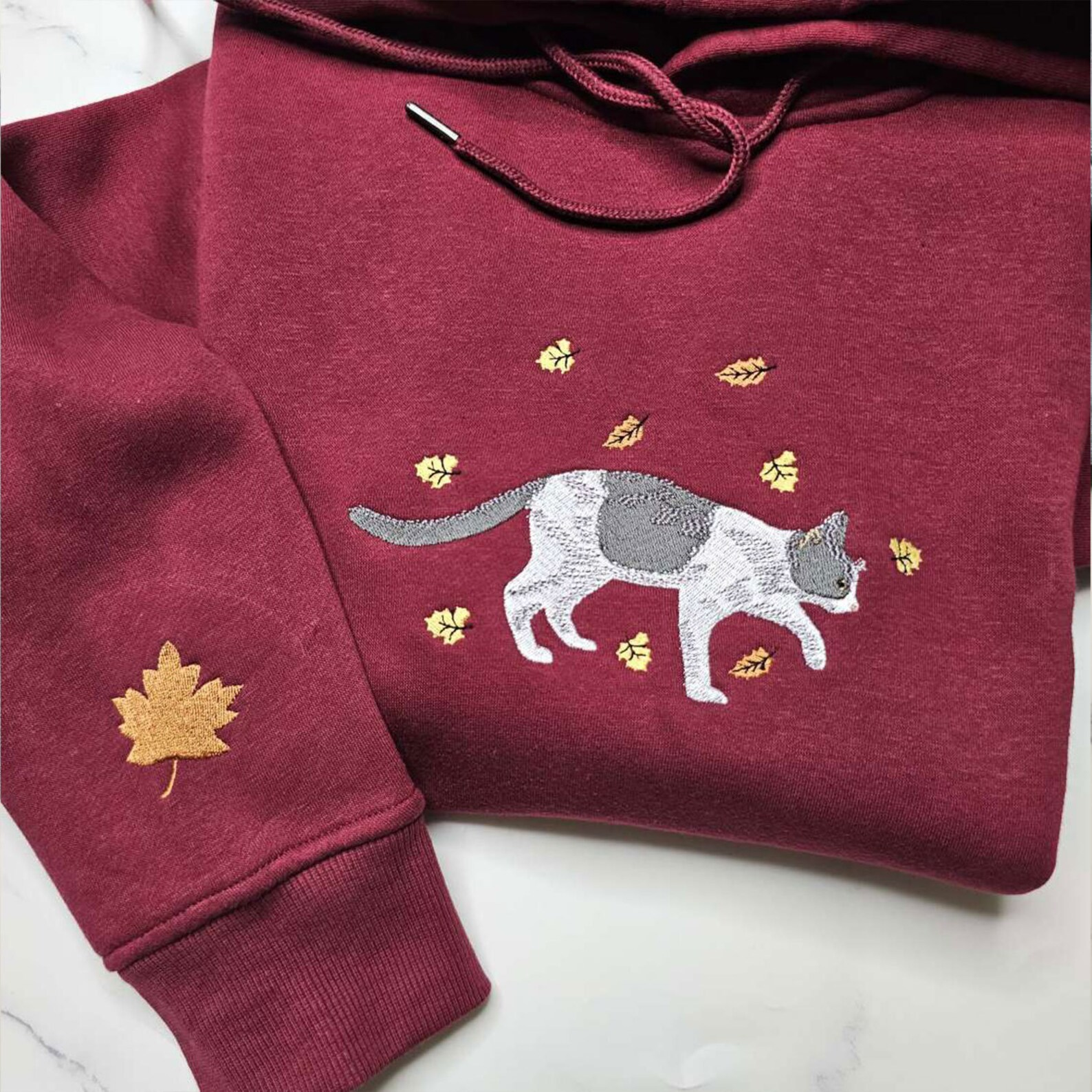 Custom pet hoodie with embroidered fall leaves and pet design - perfect custom embroidered hoodie