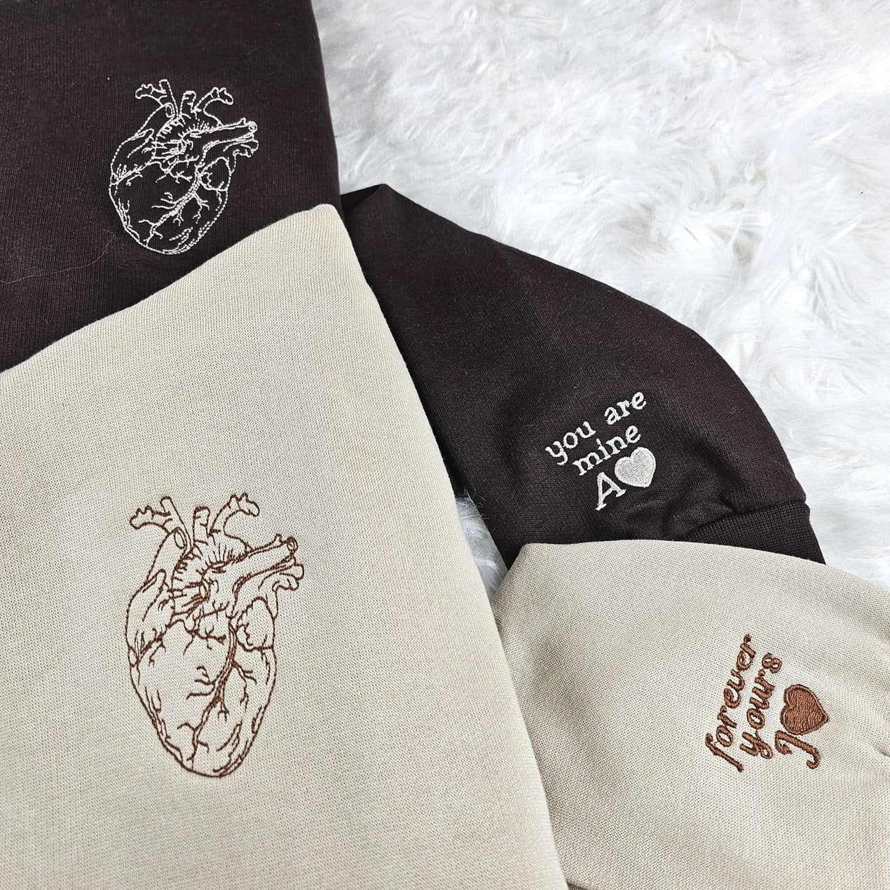 Embroidered Anatomical Heart Couple Hoodies in brown and beige with heart designs.