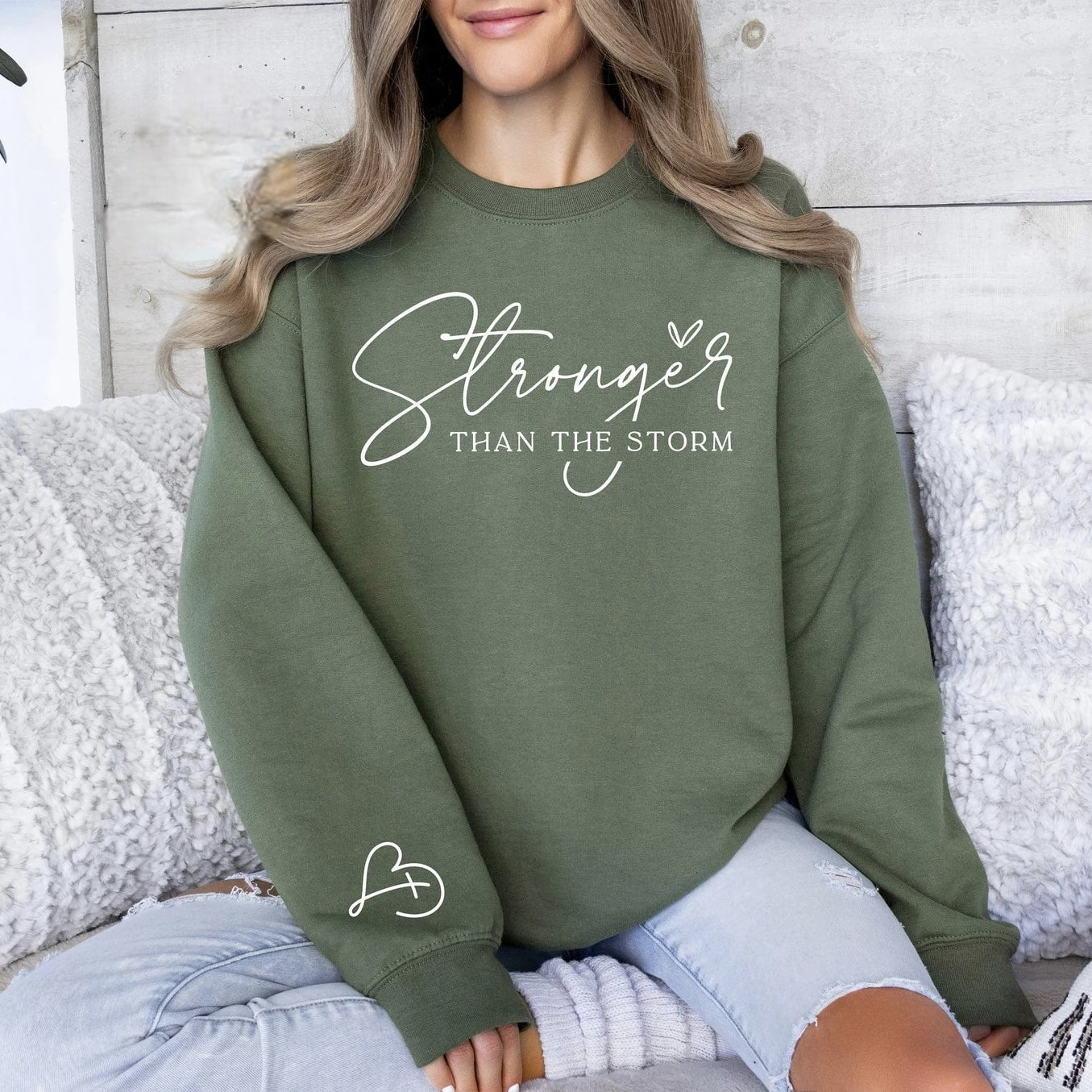 Olive green motivational sweatshirt with heart detail on sleeve.