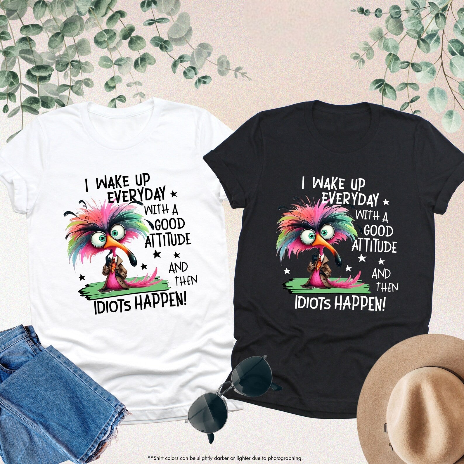 Black and white tees with vibrant bird graphic and humorous quote about life.
