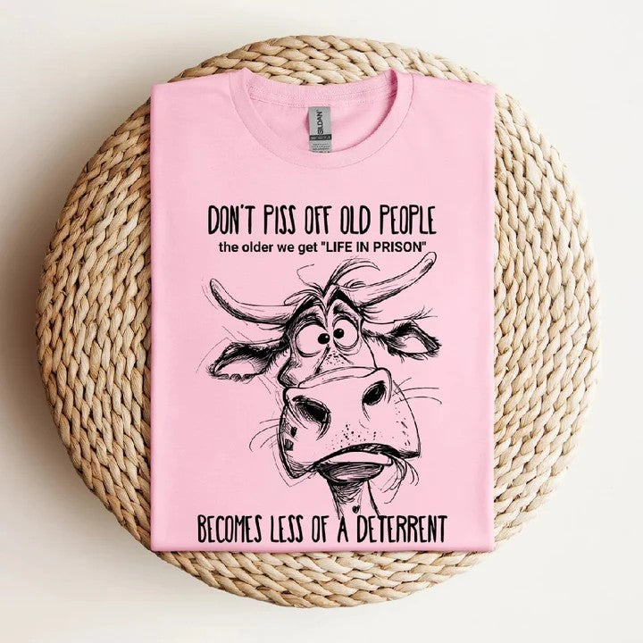 Pink funny t-shirt with grumpy cow design and playful message