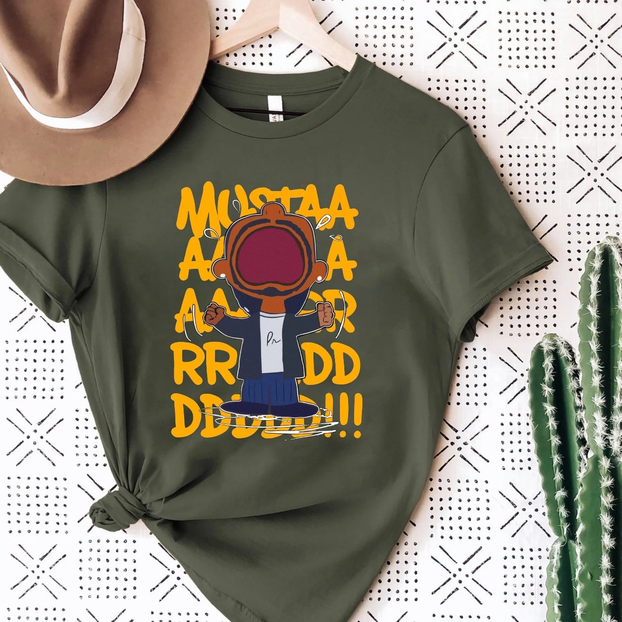 Olive green t-shirt featuring 'Mustaa Aaa Aaa RRR DDD!!!' bold graphic design.