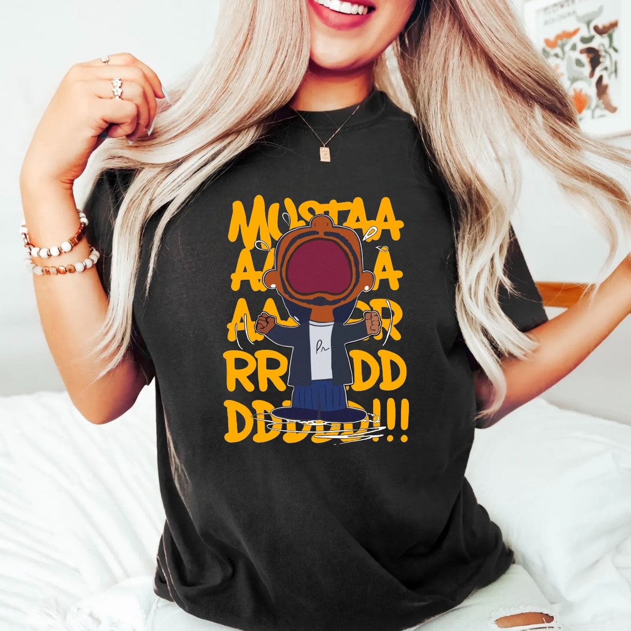 T-shirt with bold cartoon character graphic design and 'Mustaa Aaa Aaa RRR DDD!!!' slogan.