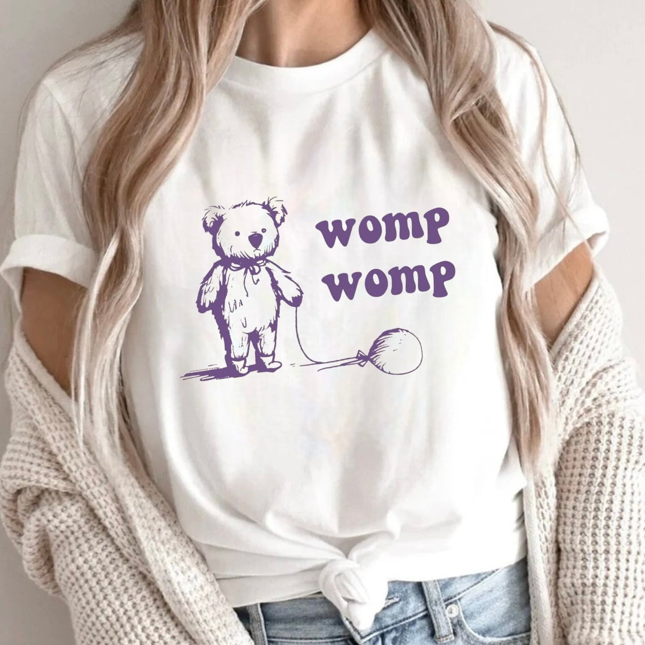 "Womp Womp" teddy bear design on a white shirt with playful text