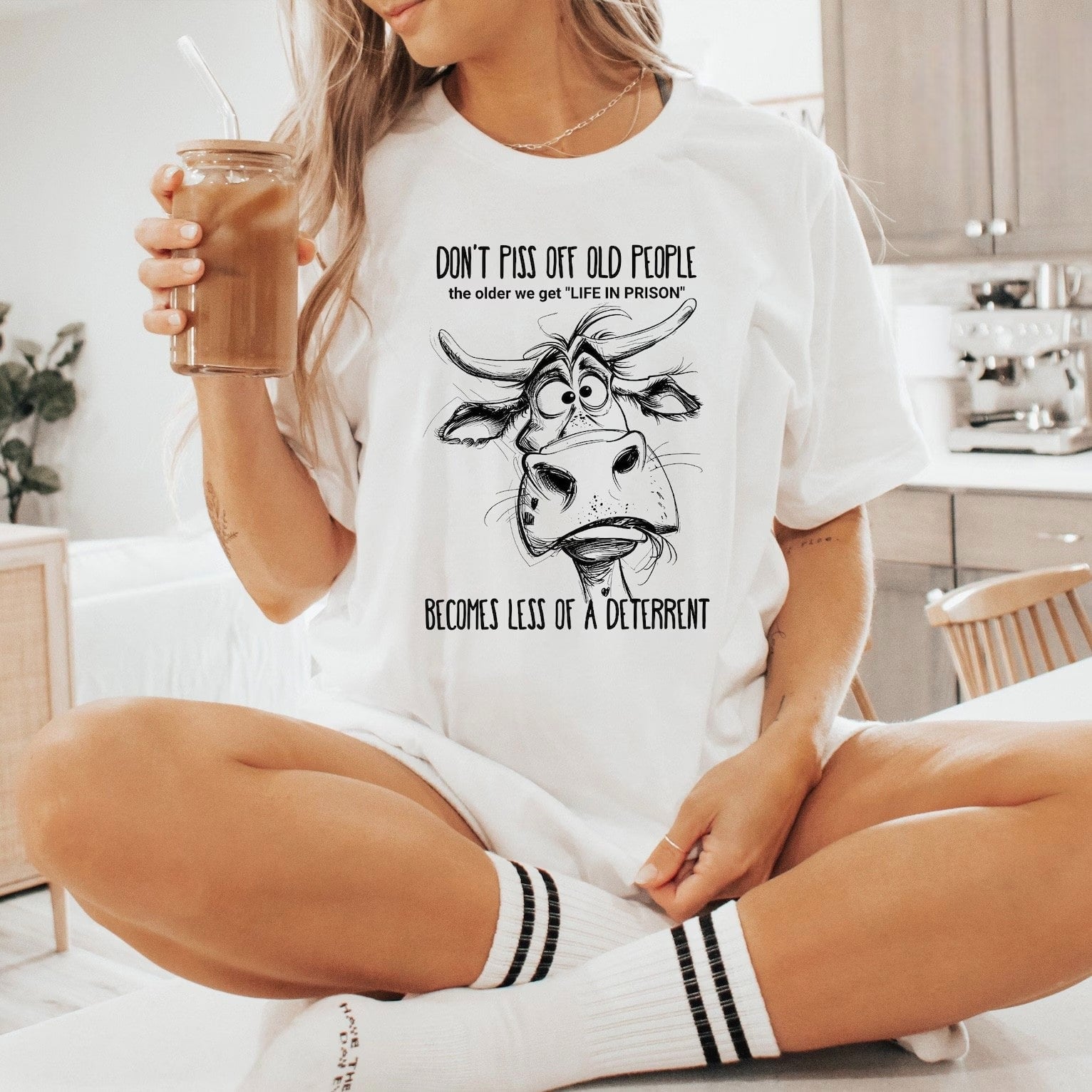 White shirt featuring comical cow and aging humor design.