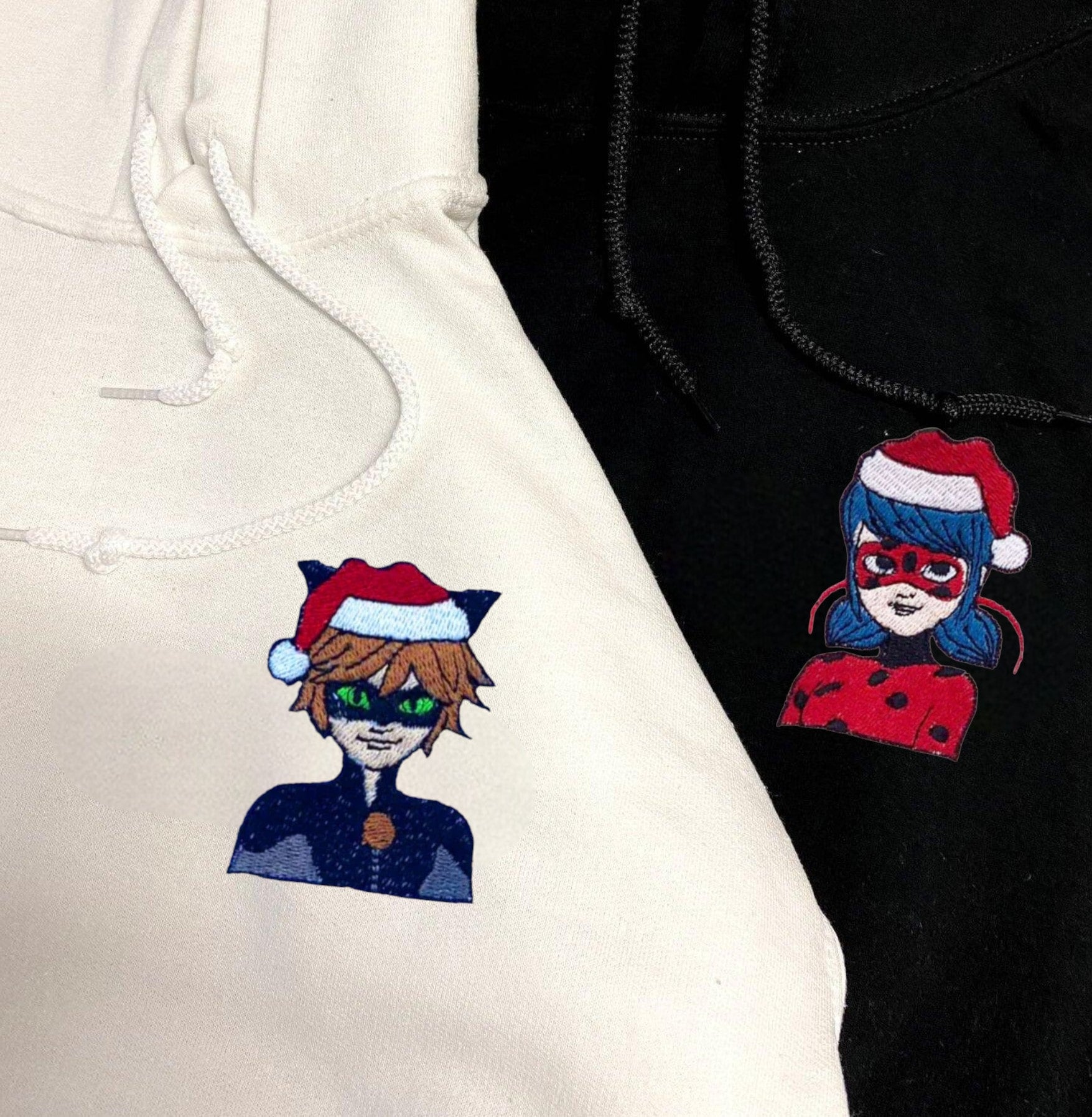 Holiday-ready couple hoodies with personalized cuffs and embroidered characters.